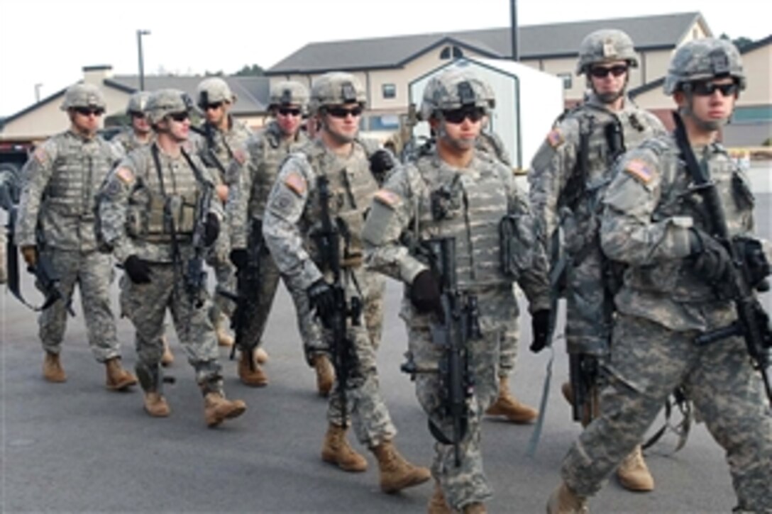 U.S. Army paratroopers move out from Fort Bragg, N.C., to buses heading for Green Ramp on Pope Air Force Base to deploy Jan. 14, 2010, to support recovery efforts in Haiti following a devastating earthquake. The paratroopers are assigned to the  82nd Airborne Division's 1st Battaltion, 73rd Cavalry Regiment, 2nd Brigade Combat Team. 