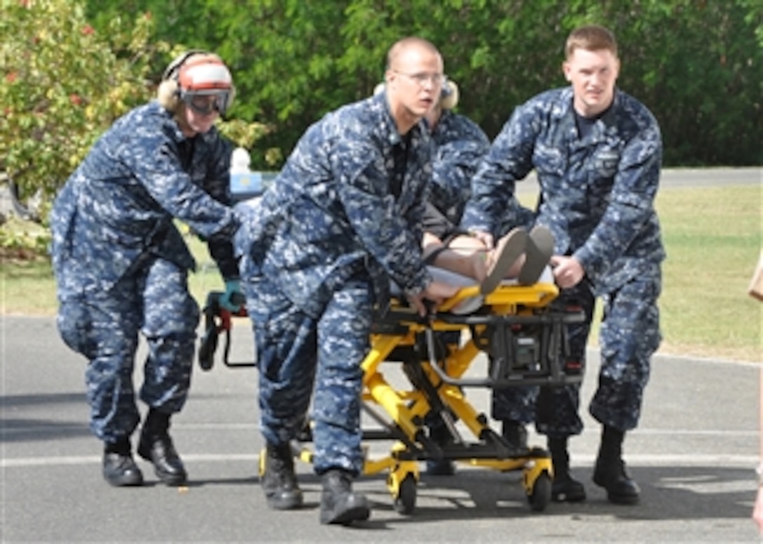 U.S. Navy sailors transport an injured U.S. citizen from a Coast Guard helicopter to the Naval Hospital at Guantanamo Bay, Cuba, on Jan. 13, 2010.  The American, an employee of the U.S. Embassy in Port-au-Prince, Haiti, was injured during a 7.0 magnitude earthquake that struck Haiti on Jan. 12, 2010.  