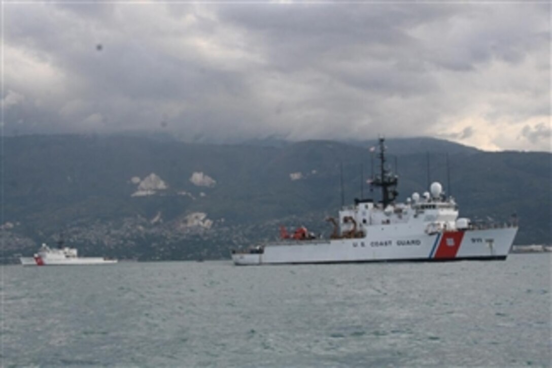 Two 270-foot U.S. Coast Guard cutters sit offshore near Haiti in preparation to provide humanitarian aid to the earthquake-ravaged country on Jan, 13, 2010.  Coast Guard personnel have been mobilized to provide support to Haiti following a 7.0 magnitude earthquake.  