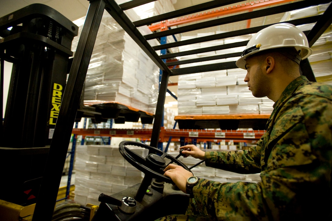 Sgt. Henry Perez-Cano, Marine Corps Institute warehouse chief, offloads a pallet of textbooks from a shelf at the Washington Navy Yard in Washington, D.C., Jan 14. Marine warehouse clerks receive forklift training and certification as part of their formal schooling.