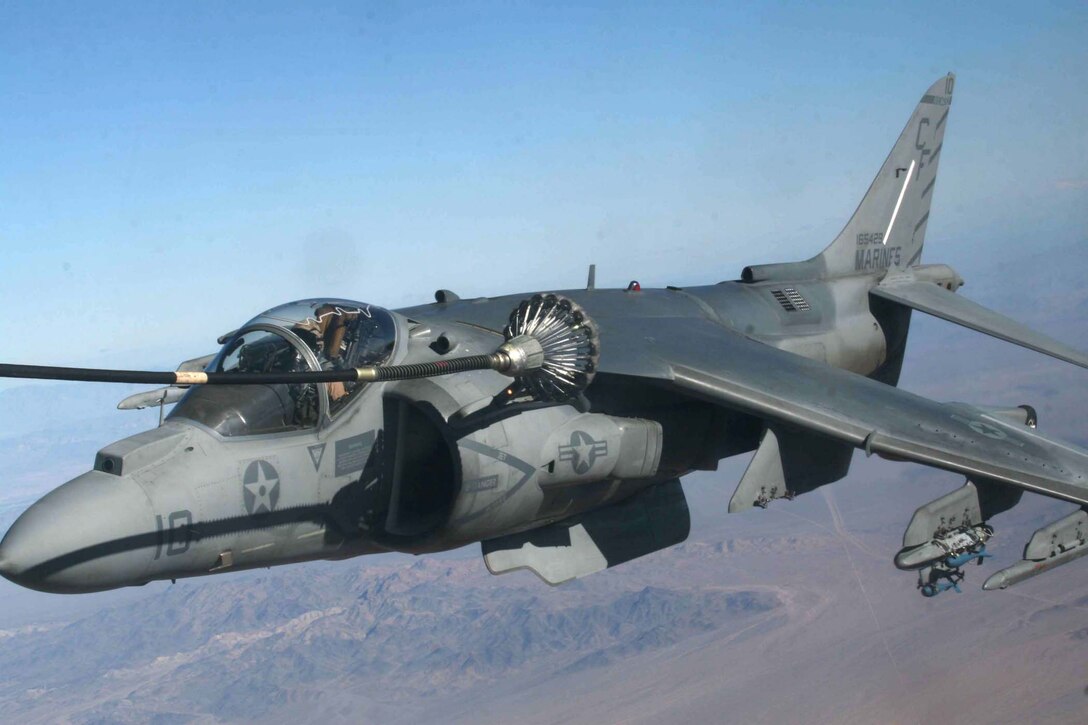 An AV-8B Harrier with Marine Attack Squadron 211 connects with refueling tube from a KC-130J Hercules with Marine Aerial Refueling and Transportation Squadron 352 during an aerial refueling mission over southeastern California Jan. 14.