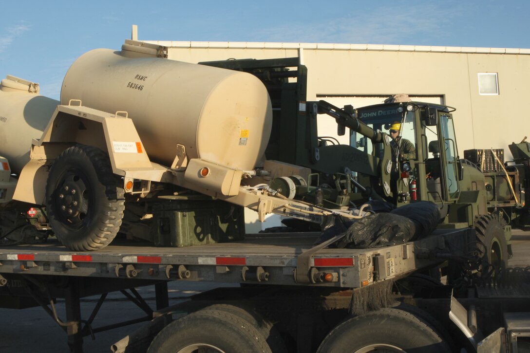 A tram operator from the 22nd Marine Expeditionary Unit prepares to pick up a water storage unit on the pier at Morehead City, N.C. to load it onto the amphibioius assault ships USS Bataan, Carter Hall and Fort McHenry, Jan. 15, 2009.  The 22nd MEU will deploy to the earthquake-ravaged Caribbean nation of Haiti to conduct sea-based humanitarian assisstance and disaster relief.