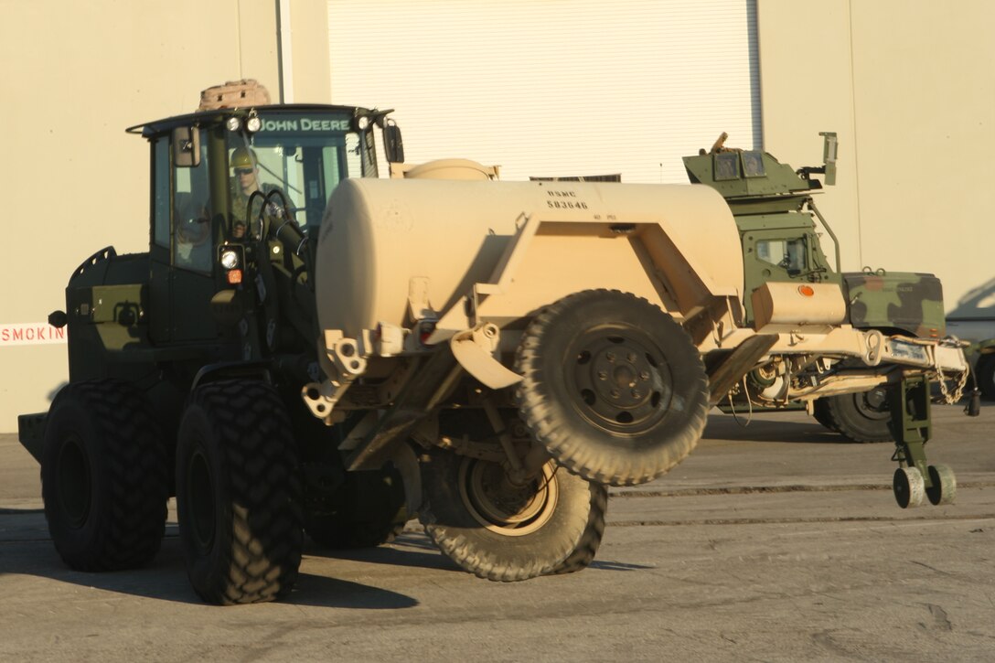 A tram operator from the 22nd Marine Expeditionary Unit moves a water storage unit on the pier at Morehead City, N.C. in preparation of loading it onto the amphibioius assault ships USS Bataan, Jan. 15, 2009.  The 22nd MEU will deploy to the earthquake-ravaged Caribbean nation of Haiti to conduct sea-based humanitarian assisstance and disaster relief.