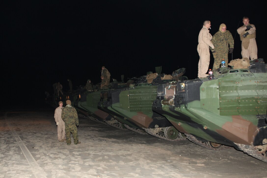 A platoon of assault amphibian vehicles wait for the order to enter the Atlantic Ocean off Onslow Beach aboard Camp Lejeune, N.C., Jan. 16, 2010.  A platoon of AAVs left Camp Lejeune in the pre-dawn hours to join the 22nd Marine Expeditionary embarked aboard the Bataan Amphibious Ready Group as it prepares to deploy to the Caribbean island nation of Haiti to provide sea-based disaster relief and humanitarian assistance in the wake of an earthquake that devestated the country on Jan. 12.