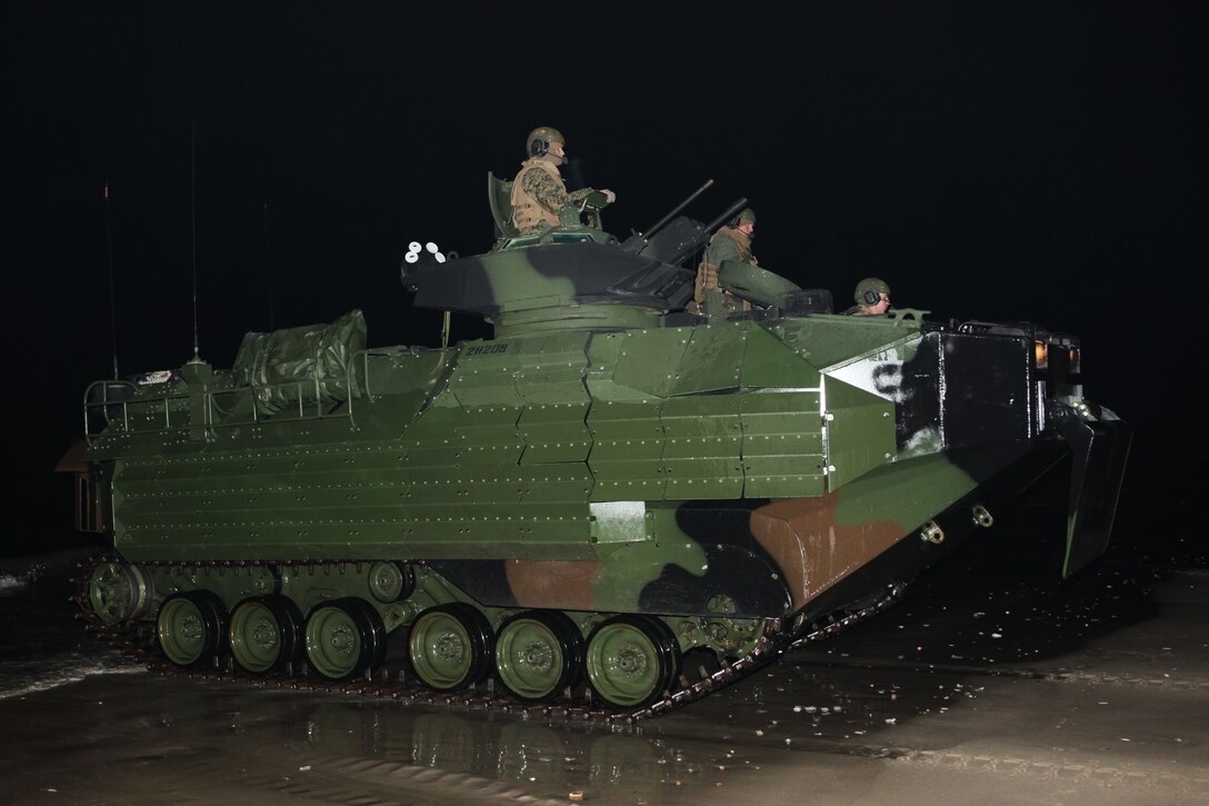 An assault amphibian vehicle drives across Onslow Beach aboard Camp Lejeune, N.C., Jan. 16, 2010.  A platoon of AAVs left Camp Lejeune in the pre-dawn hours to join the 22nd Marine Expeditionary embarked aboard the Bataan Amphibious Ready Group as it prepares to deploy to the Caribbean island nation of Haiti to provide sea-based disaster relief and humanitarian assistance in the wake of an earthquake that devestated the country on Jan. 12.