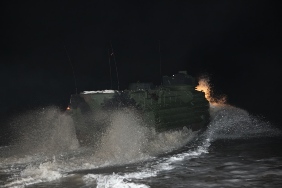 An assault amphibian vehicle splashes through the surf of Onslow Beach on Camp Lejeune, N.C., Jan. 16, 2010.  A platoon of AAVs left Camp Lejeune in the pre-dawn hours to join the 22nd Marine Expeditionary embarked aboard the Bataan Amphibious Ready Group as it prepares to deploy to the Caribbean island nation of Haiti to provide sea-based disaster relief and humanitarian assistance in the wake of an earthquake that devestated the country on Jan. 12.