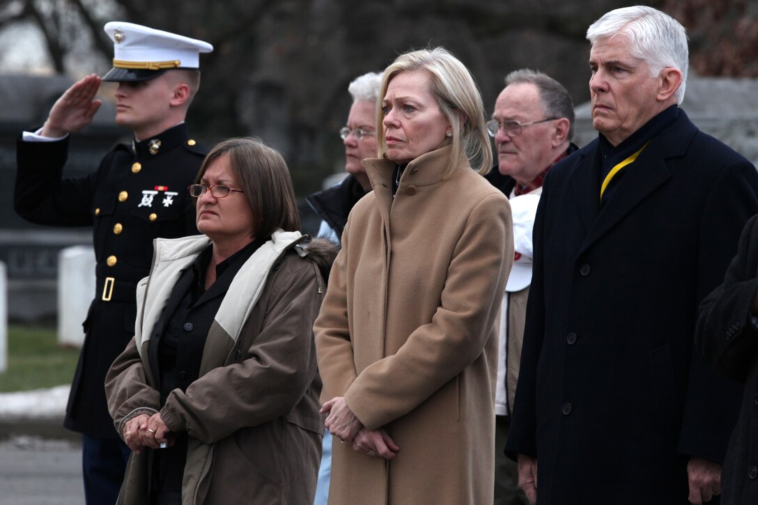 Jacqueline Mackin-Hartman (center), the daughter of retired Col. Alvin Mackin, and her husband, Robert Hartman, watch as Marines place Mackin’s remains in the funeral caisson at Arlington National Cemetery in Arlington, Va., Jan. 15, 2010. Mackin-Hartman said she was proud to see the impact her father had on the Marines who came to pay their final respects to him.