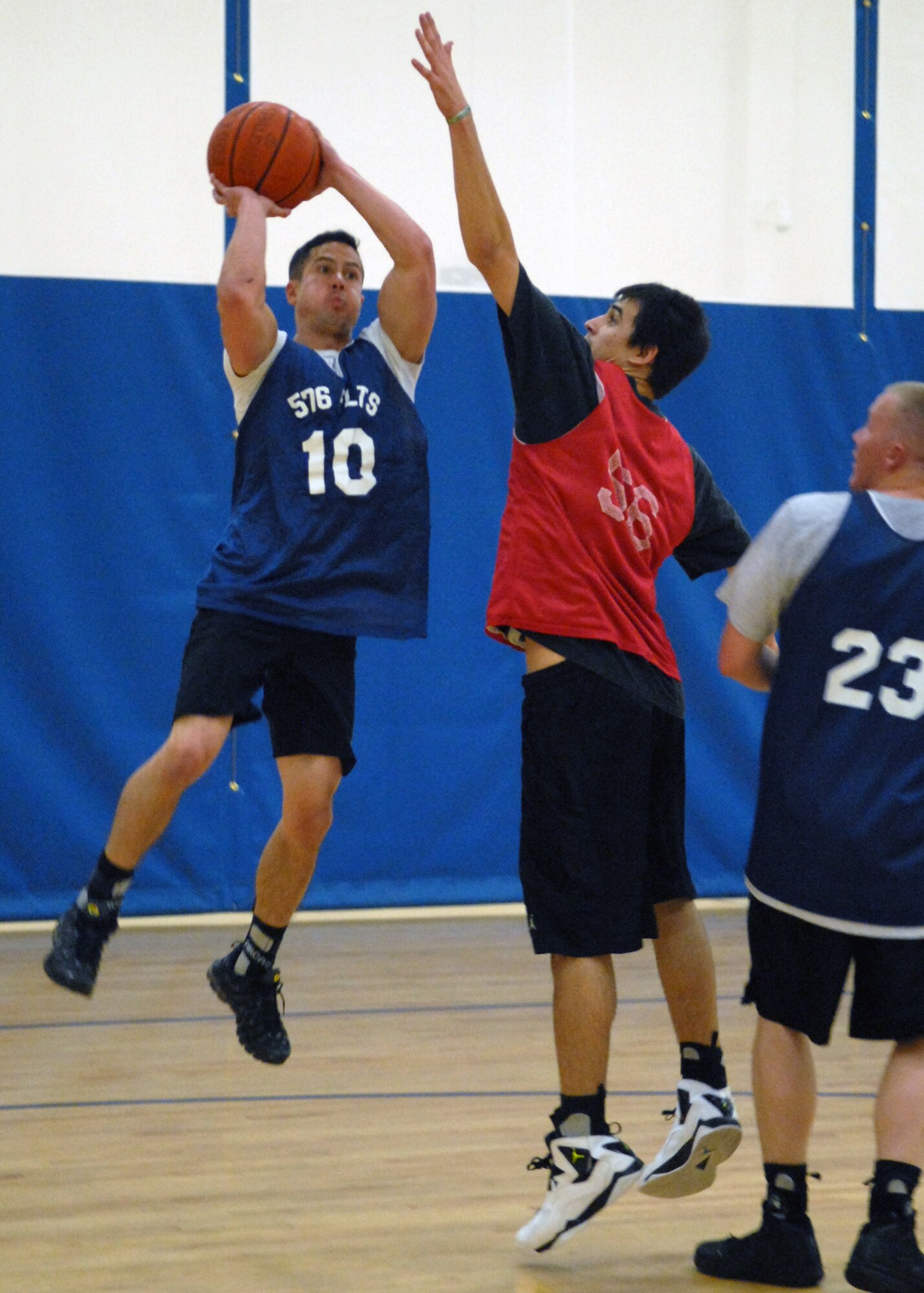 VANDENBERG AIR FORCE BASE, Calif. - From the far corner of the court, Jonathan Tillery, of the 576th Flight Test Squadron, attempts to make a shot through defender, Charles Broadhead, here Wednesday, Jan. 13, 2010. Kicking off the intramural basketball season the 30th Medical Group beat the 576th Flight Test Squadron 77-40. (U.S. Air Force photo/ Airman 1st Class Angelina Drake)

