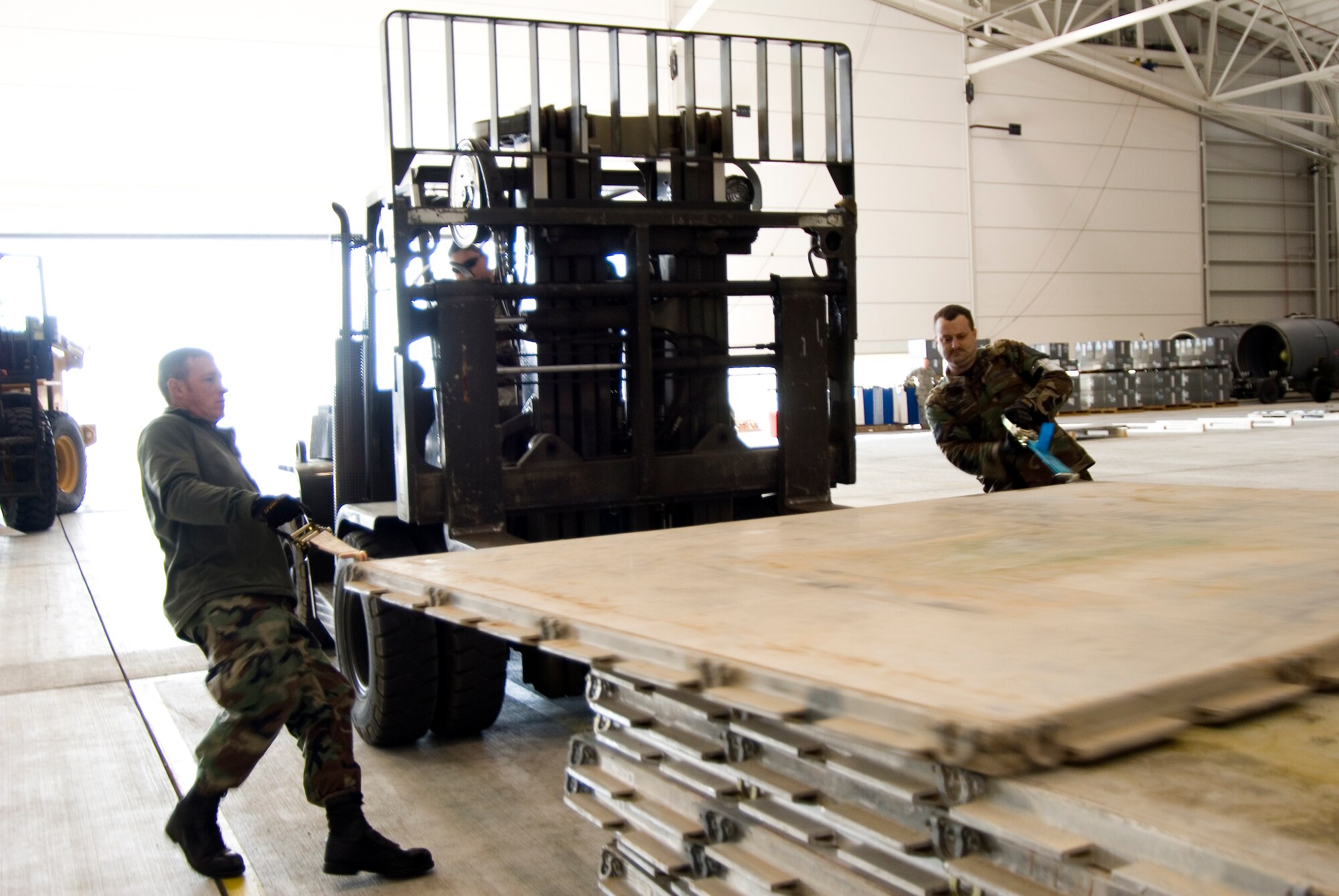 Tech. Sgt. Jody Miller and Tech. Sgt. Darren Rebuck slide pallets onto a forklift on January 15, 2010 at the 167th Airlift Wing. The air base in Martinsburg, W.Va, was transformed Janunary 14 into a staging area for more than 332,000 pounds of supplies bound for the airport at Port-au-Prince, Haiti. Hundreds of thousands of pounds more are expected to be palletized at the base for shipment to Haiti in the coming days. (U.S. Air Force photo MSgt Emily Beightol-Deyerle)