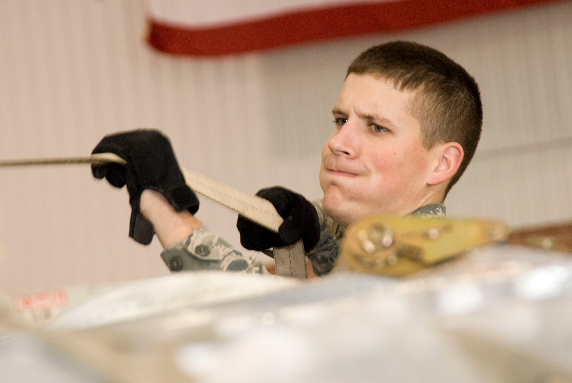 Airman 1st ClassBradley Harris tightens cargo netting over a pallet of medical supplies on January 15th, 2010 at the 167th Airlift Wing. The air base in Martinsburg, W.Va, was transformed Janunary 14 intoa staging area for more than 332,000 pounds of supplies bound for the airport at Port-au-Prince, Haiti. Hundreds of thousands of pounds more are expected to be palletized at the base for shipment to Haiti in the coming days. (U.S. Air Force photo by MSgt Emily Beightol-Deyerle)