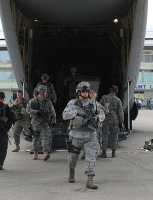 Airmen from the 621st Contingency Response Wing from Joint Base McGuire-Dix-Lakehurst, New Jersey, N.J., depart a Little Rock Air Force Base C-130 at the Port-au-Prince International Airport, Haiti, Jan. 14 to support the earthquake relief effort in Haiti.  The 621st CRW airmen are highly-specialized to quickly open airfields and establish, expand, sustain, and coordinate air mobility operations. From wartime taskings to disaster relief, the 621st extends Air Mobility Command's reach in deploying people and equipment around the globe (USAF Photo by Staff Sgt. Chad Chisholm) (Cleared by Mr. Arlo Taylor, 19th Airlift Wing Public Affairs)
