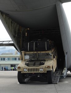 A Humvee is rapidly deployed from a 41st Airlift Squadron C-130J during an engine running off-load at the Port-au-Prince International Airport, Haiti, Jan. 14 as part of ongoing Haitian earthquake relief operations. The equipment and personnel delivered by the aircrew from Little Rock Air Force Base, Ark., will be used for conducting an airfield assessment in support of the earthquake relief in Haiti.  (USAF Photo by Staff Sgt. Chad Chisholm) (Cleared by Mr. Arlo Taylor, 19th Airlift Wing Public Affairs)