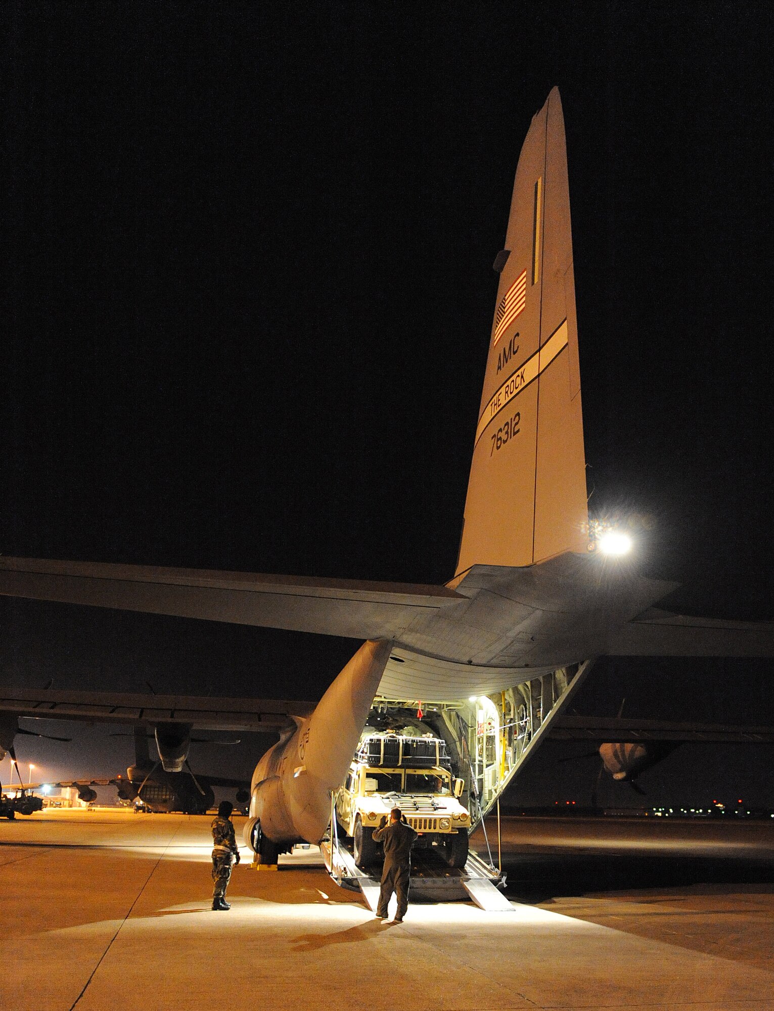 Staff Sgt. Lynzey Thorton, 41st Airlift Squadron Loadmaster, guides a Humvee into the back of a C-130J Jan. 14 at the Biloxi-Gulfport International Airport, Miss., as part of their mission to deliver equipment and personnel to support the Haitian relief effort. The aircraft launched from Little Rock Air Force Base, Ark., near midnight Jan. 13, loaded personnel and equipment before dawn Jan. 14 at Biloxi-Gulfport International Airport, Miss., and delivered them the morning of Jan. 14 as part of on-going Haitian relief efforts.  (USAF Photo by Staff Sgt. Chad Chisholm) (Cleared by Mr. Arlo Taylor, 19th Airlift Wing Public Affairs)