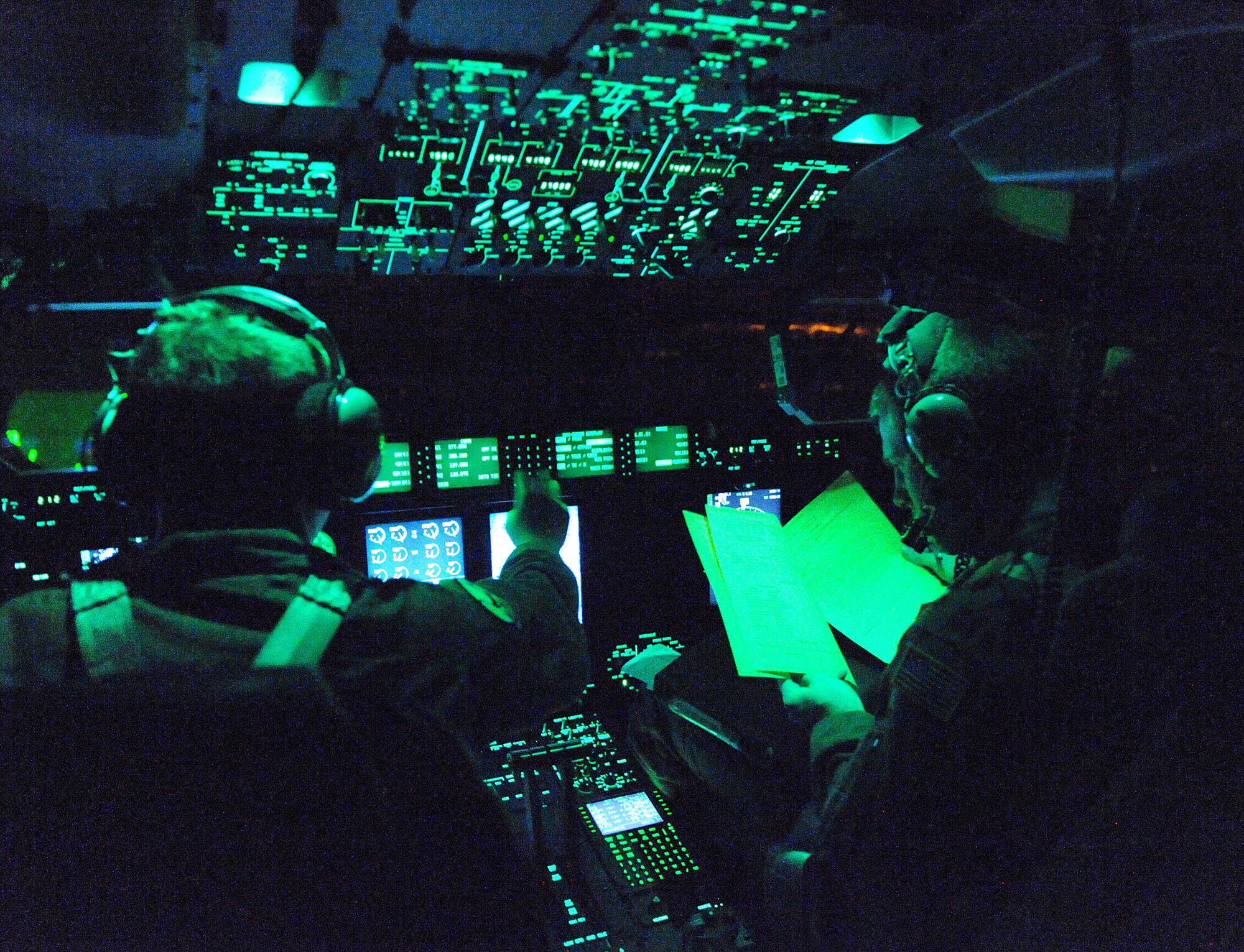 Captain Jeff Smith, 41st Airlift Squadron aircraft commander, (left) and Capt. Andy Marshal, 41st AS co-pilot, prepare to land their C-130J aircraft Jan. 14 at the Biloxi-Gulfport International Airport, Miss., to pick up equipment and personnel to support the earthquake relief effort in Haiti. The aircraft launched from Little Rock Air Force Base, Ark., near midnight Jan. 13, loaded personnel and equipment before dawn Jan. 14 at Biloxi-Gulfport International Airport, Miss., and delivered them to the Port-au-Prince International Airport, Haiti, the morning of Jan. 14 as part of on-going Haitian relief efforts. (USAF Photo by Staff Sgt. Chad Chisholm) (Cleared by Mr. Arlo Taylor, 19th Airlift Wing Public Affairs)
