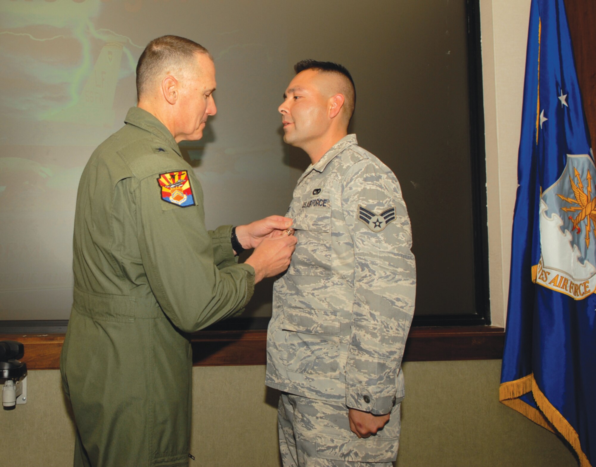 Brig. Gen. Kurt Neubauer, 56th Fighter Wing commander, awards Senior Airman Johnny Martinez, 56th Logistics Readiness Squadron, the Bronze Star for his actions during his first deployment to Afghanistan from August 2008 to August 2009. (U.S. Air Force photo by Airman 1st Class Ronifel Yasay)
