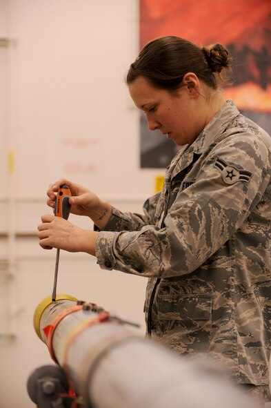 MOODY AIR FORCE BASE, Ga. -- Airman 1st Class Melissa Kmon, 23rd Equipment Maintenance Squadron munitions flight precision guided missile crewmember, removes a segment of a missile seeker head assembly during a Phase I Operational Readiness Exercise here Jan. 11. The munitions flight performed thorough inspections on all missiles delivered to the flight line.  (U.S. Air Force photo by Airman 1st Class Benjamin Wiseman)