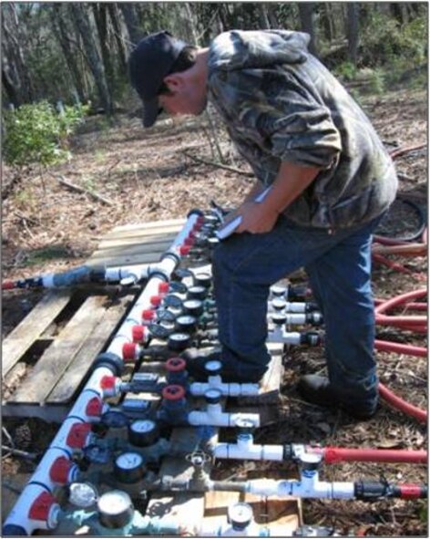 MOODY AIR FORCE BASE, Ga. -- A contractor monitors the injection quantities here by reading meters that help regulate the quantity and pressure of in-situ enhanced bioremediation injectors. The ISEB injections are one of two processes that Moody is using to remedy sites that were contaminated before laws took place in the 1980s, which made organizations responsible for the waste they created. (Contributed photo)