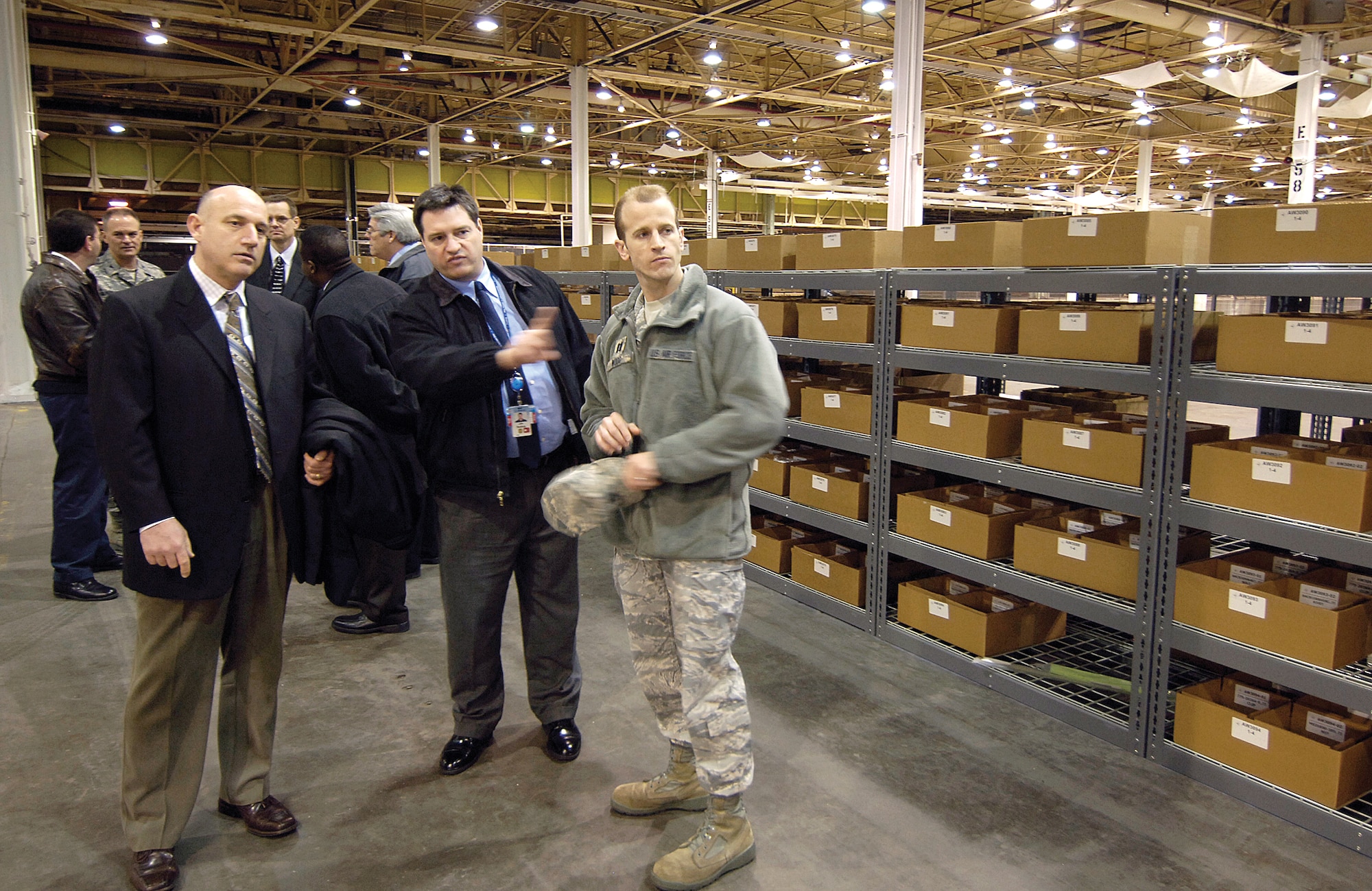 During the grand opening ceremony for new warehouse space in Bldg. 9001, attendees including Rick Heerdt, Jim Reding and Capt. Butch Wood, from left, toured the 38,000 square-foot space filled with parts for the largest E-3 modification in history. The upgrades at Tinker begin in November. Mr. Heerdt and Mr. Reding are with Boeing and Captain Wood is with the 636th Electronic Systems Squadron at Hanscom AFB, Mass. (Air Force photo by Margo Wright)