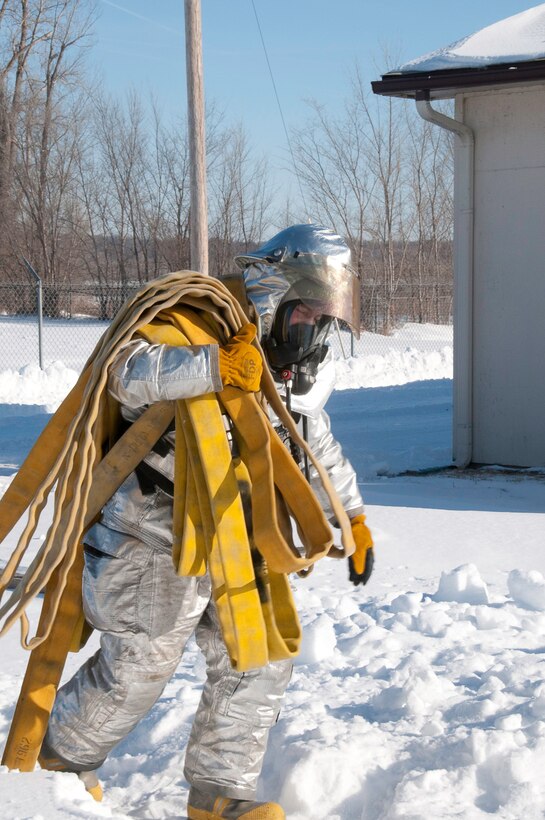 139th Airlift Wing Fire Department members respond to a simulated structural fire during an exercise, conducted as part of a unit compliance inspection on January 10, 2010. (U.S. Air Force photo by Master Sgt. Shannon Bond) (RELEASED)