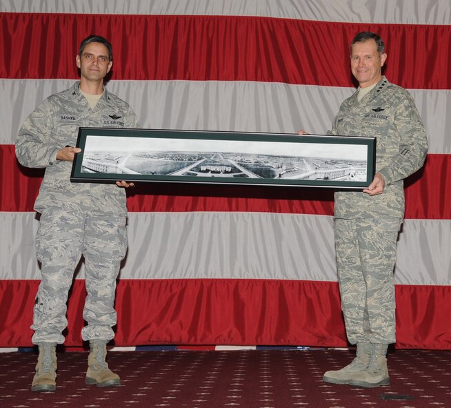 Barksdale AFB, La. - Col. Steven Basham, 2d Bomb Wing commander, presents a photo and frame to Gen. William Fraser, Air Combat Command commander, during the All-Call Jan. 12. All Barksdale Airmen attended a mass assembly at Hoban Hall to listen to General Fraser. (U.S. Air Force photo by Senior Airman Alexandra M. Longfellow) (RELEASED)