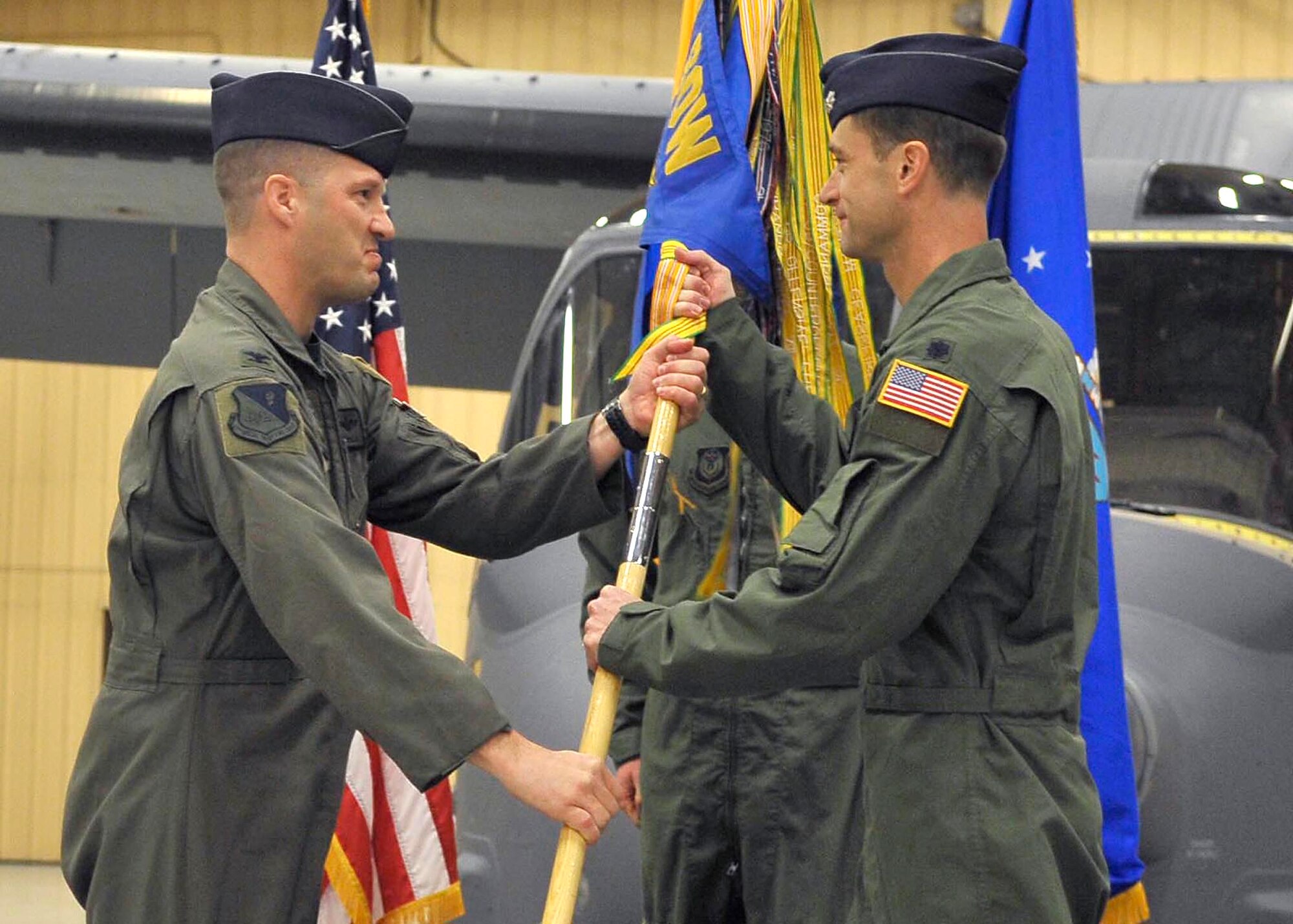 CANNON AIR FORCE BASE, N.M. -- Col. James Cardoso, 27th Special Operations Group commander, presents the 20th Special Operations Squadron guidon to Lt. Col. Matthew Smith, its newest commander, during a reactivation ceremony Dec. 15. The 20th Special Operations Squadron was previously assigned to the 1st Special Operations Group, Hurlburt Field, Fla,  (U.S. Air Force photo by Staff Sgt. Heather R. Redman)