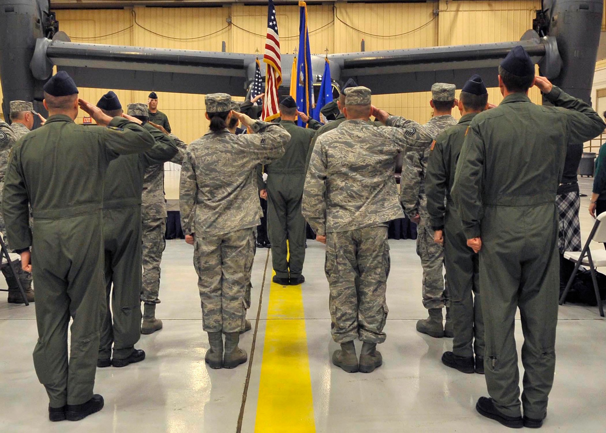 CANNON AIR FORCE BASE, N.M. -- Members of the 20th Special Operations Squadron salute the flag during the playing of the National Anthem during the squadron's reactivation ceremony Dec. 15. The unit will operate the CV-22 Osprey aircraft in support of special operations missions as the 27th Special Operation Wing's newest squadron.  (U.S. Air Force photo by Staff Sgt. Heather R. Redman)
