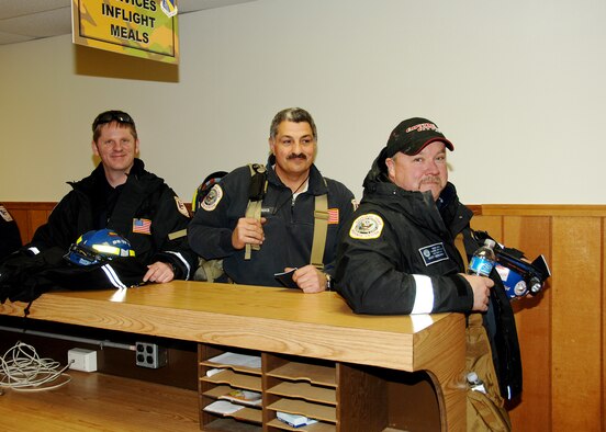 Firefighters (l to r) Tyson Dean, Edward Thomas and Scott Benjamin move through the processing line at Wright-Patterson Air Force Base, Ohio, on Jan. 14, 2010, while preparing to deploy to Haiti. They are members of Ohio Task Force One, an urban search and rescue team consisting of about 80 highly-trained volunteer first-responders from across Ohio and northern Kentucky. The team is staged at the base while awaiting airlift into Port au Prince, Haiti. (U.S. Air Force photo/Ben Strasser)