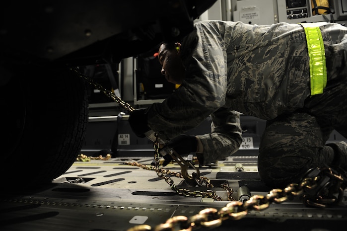 U.S. Air Force personnel from the 621st   Contingency Response Wing, Joint Base McGuire-Dix-Lakehurst, N.J., load cargo onto a Charleston Air Force Base, S.C., C-17 Globemaster III, supporting a swift and coordinated relief effort to Haiti, Jan. 14, 2010, in the aftermath of a devastating earthquake.  (U.S. Air Force photo by Staff Sgt. Joshua L. DeMotts) (Released)