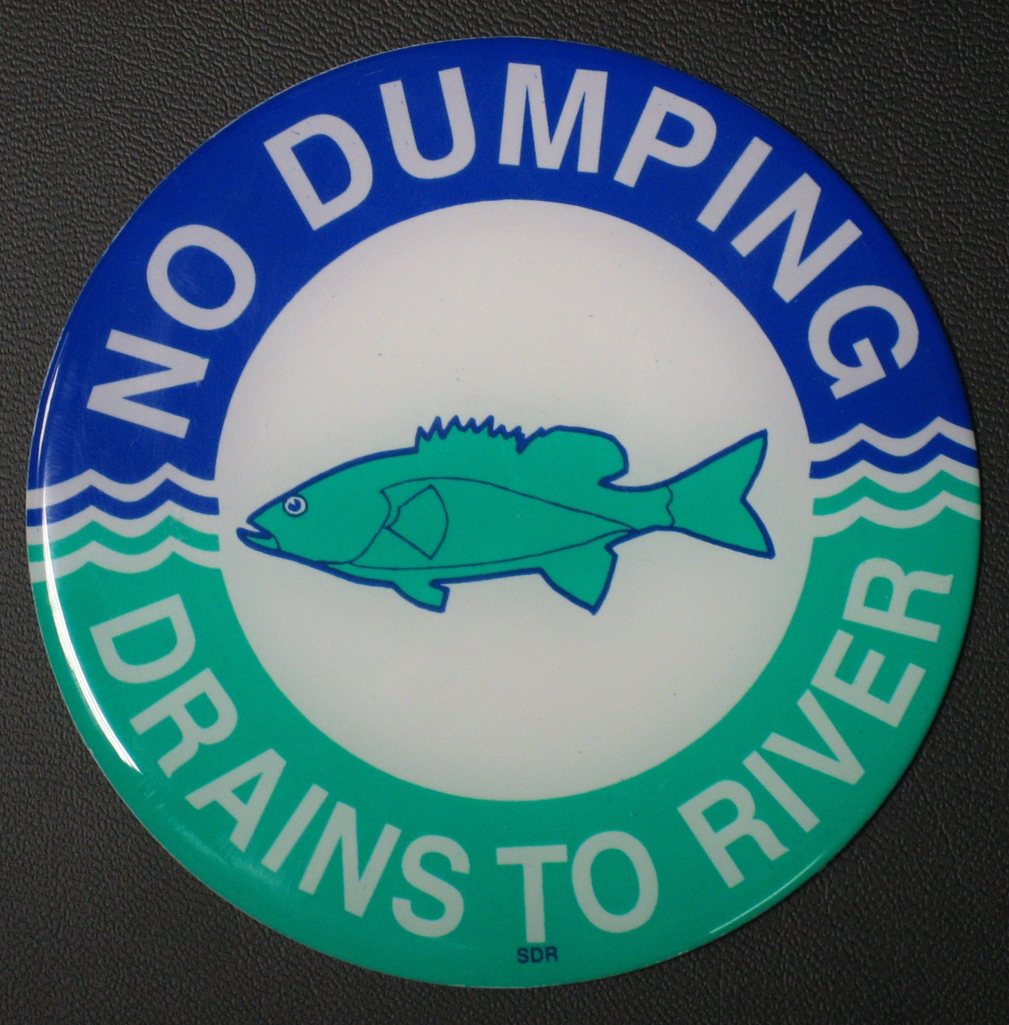 The base has approximately 2,000 catch basins with the fish sticker to identify it’s for water only.  (U.S. Air Force photo by Ted Theopolos).