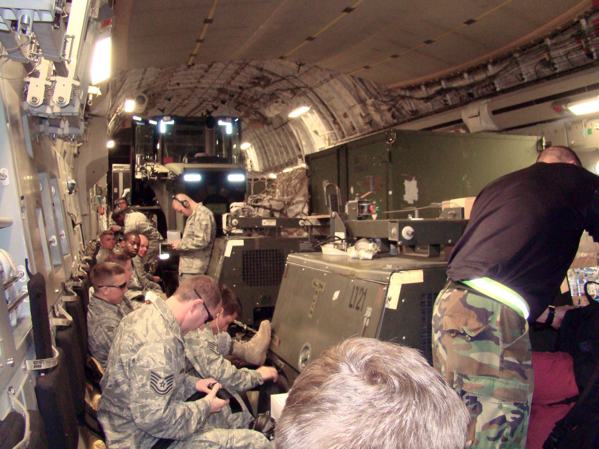 Members of the 621st Contingency Response Wing depart on board a C-17 Globemaster III Jan. 14, 2010, from Joint Base McGuire-Dix-Lakehurst, N.J., and headed for the Toussaint L'Ouverture International Airport, Haiti. The 21 passengers and 44 tons of cargo were sent to Haiti on a 305th Air Mobility Wing C-17 from Joint Base McGuire to support relief operations in response to a devastating earthquake in the area. (U.S. Air Force photo/Tech. Sgt. Denise Johnson)
