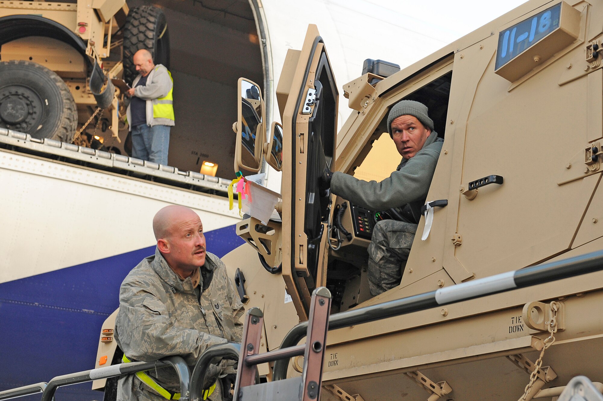 Tech. Sgt. Keith Cloninger (ground) and Tech. Sgt. Mark Forman use a 25K Loader to off load a mine-resistant, ambush-protected all-terrain vehicles Jan. 13, 2010 at Bagram Airfield, Afghanistan. Sergeants Cloninger and Forman are assigned to the 455th Expeditionary Aerial Port Squadron. (U.S. Air Force photo/Tech. Sgt. Jeromy K. Cross)