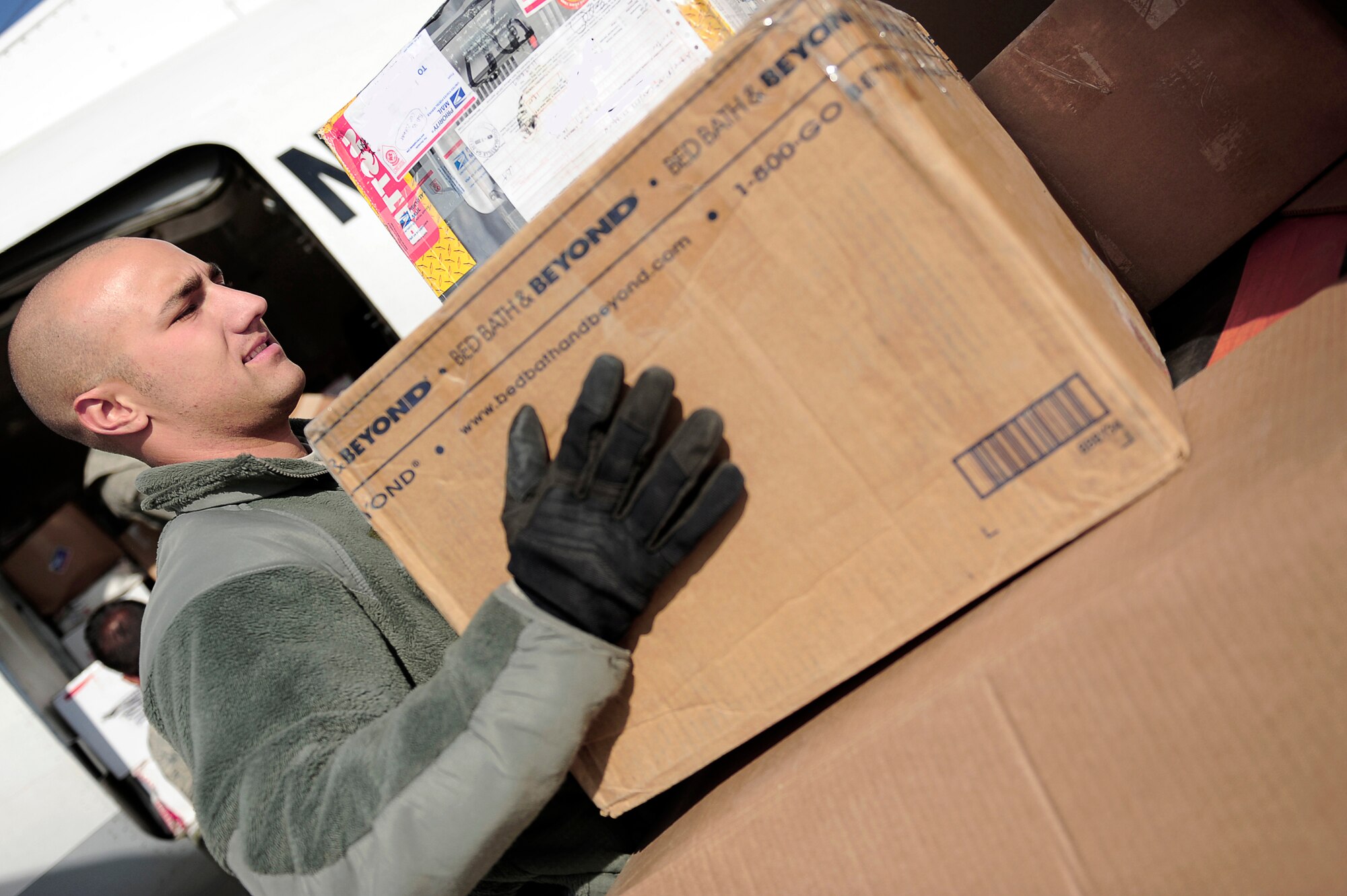 Senior Airman Joshua Shaffer loads mail into an aircraft outbound to a nearby forward operating base Jan.12, 2010 at Bagram Airfield, Afghanistan. Airman Shaffer is assigned to the 455th Expeditionary Aerial Port Squadron. (U.S. Air Force photo/Tech. Sgt. Jeromy K. Cross)