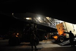 U.S.Air Force personnel from the 621st Contingency Response Wing, Joint Base McGuire-Dix-Lakehurst, N.J., off load cargo from a Charleston Air Force Base, S.C., C-17 Globemaster III, Jan. 15, 2010, at the Port-au-Princce airport in support relief efforts to Haiti  in the aftermath of a devastating earthquake.  (U.S. Air Force photo by Staff Sgt. Joshua L. DeMotts) (Released)