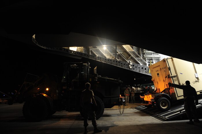 U.S.Air Force personnel from the 621st Contingency Response Wing, Joint Base McGuire-Dix-Lakehurst, N.J., off load cargo from a Charleston Air Force Base, S.C., C-17 Globemaster III, Jan. 15, 2010, at the Port-au-Princce airport in support relief efforts to Haiti  in the aftermath of a devastating earthquake.  (U.S. Air Force photo by Staff Sgt. Joshua L. DeMotts) (Released)