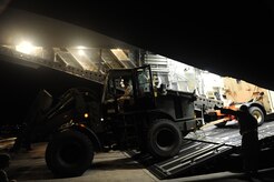 U.S.Air Force personnel from the 621st Contingency Response Wing, Joint Base McGuire-Dix-Lakehurst, N.J., off load cargo from a Charleston Air Force Base, S.C., C-17 Globemaster III, Jan. 15, 2010, at the Port-au-Princce airport in support relief efforts to Haiti  in the aftermath of a devastating earthquake.  (U.S. Air Force photo by Staff Sgt. Joshua L. DeMotts) (Released)