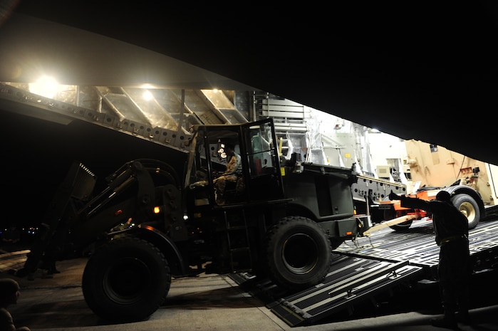U.S.Air Force personnel from the 621st Contingency Response Wing, Joint Base McGuire-Dix-Lakehurst, N.J., off load cargo from a Charleston Air Force Base, S.C., C-17 Globemaster III, Jan. 15, 2010, at the Port-au-Princce airport in support relief efforts to Haiti  in the aftermath of a devastating earthquake.  (U.S. Air Force photo by Staff Sgt. Joshua L. DeMotts) (Released)