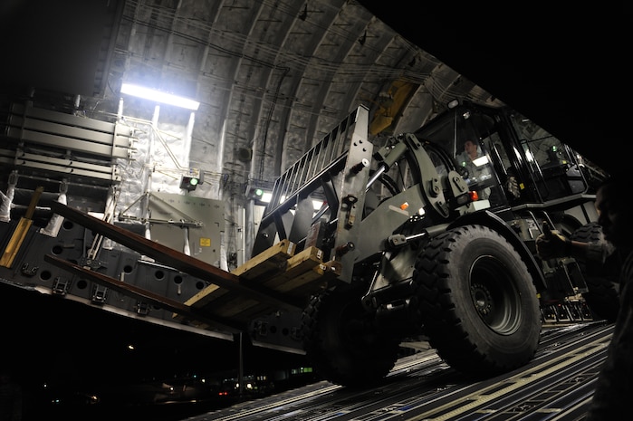 U.S.Air Force personnel from the 621st Contingency Response Wing, Joint Base McGuire-Dix-Lakehurst, N.J., off load cargo from a Charleston Air Force Base, S.C., C-17 Globemaster III, Jan. 15, 2010, at the Port-au-Princce airport in support relief efforts to Haiti  in the aftermath of a devastating earthquake.  (U.S. Air Force photo by Staff Sgt. Joshua L. DeMotts) (Released)