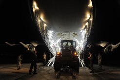 U.S.Air Force personnel from the 621st Contingency Response Wing, Joint Base McGuire-Dix-Lakehurst, N.J., off load cargo from a Charleston Air Force Base, S.C., C-17 Globemaster III, Jan. 15, 2010, at the Port-au-Princce airport in support relief efforts to Haiti  in the aftermath of a devastating earthquake.  (U.S. Air Force photo by Staff Sgt. Joshua L. DeMotts) (Released)