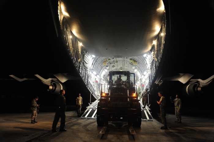 U.S.Air Force personnel from the 621st Contingency Response Wing, Joint Base McGuire-Dix-Lakehurst, N.J., off load cargo from a Charleston Air Force Base, S.C., C-17 Globemaster III, Jan. 15, 2010, at the Port-au-Princce airport in support relief efforts to Haiti  in the aftermath of a devastating earthquake.  (U.S. Air Force photo by Staff Sgt. Joshua L. DeMotts) (Released)