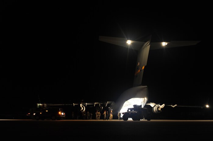 U.S.Air Force personnel from the 621st Contingency Response Wing, Joint Base McGuire-Dix-Lakehurst, N.J., off load cargo from a Charleston Air Force Base, S.C., C-17 Globemaster III, Jan. 15, 2010, at the Port-au-Princce airport in support relief efforts to Haiti  in the aftermath of a devastating earthquake.  (U.S. Air Force photo by Staff Sgt. Joshua L. DeMotts) (Released)
