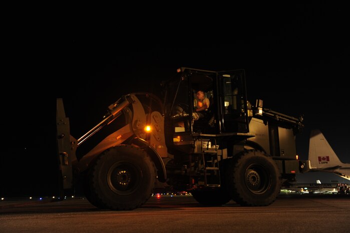 U.S.Air Force personnel from the 621st Contingency Response Wing, Joint Base McGuire-Dix-Lakehurst, N.J., off load cargo from a Charleston Air Force Base, S.C., C-17 Globemaster III, Jan. 15, 2010, at the Port-au-Princce airport in support relief efforts to Haiti  in the aftermath of a devastating earthquake.  (U.S. Air Force photo by Staff Sgt. Joshua L. DeMotts) (Released)
