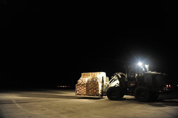 U.S.Air Force personnel from the 621st Contingency Response Wing, Joint Base McGuire-Dix-Lakehurst, N.J., off load cargo from a Charleston Air Force Base, S.C., C-17 Globemaster III, Jan. 15, 2010, at the Port-au-Princce airport in support relief efforts to Haiti  in the aftermath of a devastating earthquake.  (U.S. Air Force photo by Staff Sgt. Joshua L. DeMotts) (Released)