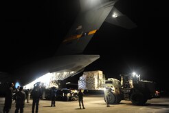 U.S.Air Force personnel from the 621st Contingency Response Wing, Joint Base McGuire-Dix-Lakehurst, N.J., off load cargo from a Charleston Air Force Base, S.C., C-17 Globemaster III, Jan. 15, 2010, at the Port-au-Princce airport in support relief efforts to Haiti  in the aftermath of a devastating earthquake.  (U.S. Air Force photo by Staff Sgt. Joshua L. DeMotts) (Released)