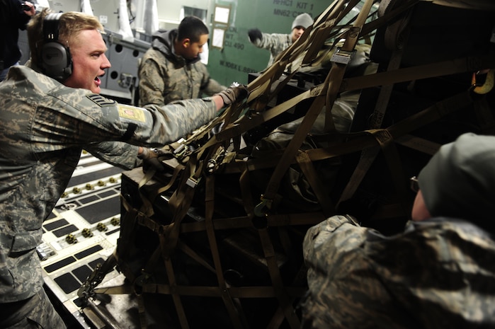 U.S. Air Force personnel from the 621st   Contingency Response Wing, Joint Base McGuire-Dix-Lakehurst, N.J., load cargo onto a Charleston Air Force Base, S.C., C-17 Globemaster III, supporting a swift and coordinated relief effort to Haiti, Jan. 14, 2010, in the aftermath of a devastating earthquake.  (U.S. Air Force photo by Staff Sgt. Joshua L. DeMotts) (Released)