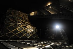 U.S. Air Force personnel from the 621st   Contingency Response Wing, Joint Base McGuire-Dix-Lakehurst, N.J., load cargo onto a Charleston Air Force Base, S.C., C-17 Globemaster III, supporting a swift and coordinated relief effort to Haiti, Jan. 14, 2010, in the aftermath of a devastating earthquake.  (U.S. Air Force photo by Staff Sgt. Joshua L. DeMotts) (Released)