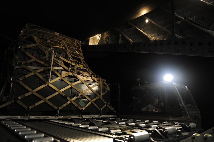 U.S. Air Force personnel from the 621st   Contingency Response Wing, Joint Base McGuire-Dix-Lakehurst, N.J., load cargo onto a Charleston Air Force Base, S.C., C-17 Globemaster III, supporting a swift and coordinated relief effort to Haiti, Jan. 14, 2010, in the aftermath of a devastating earthquake.  (U.S. Air Force photo by Staff Sgt. Joshua L. DeMotts) (Released)