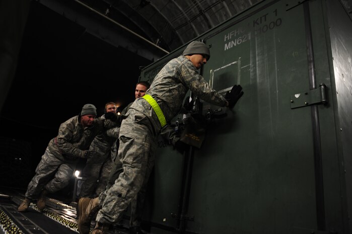 U.S. Air Force personnel from the 621st   Contingency Response Wing, Joint Base McGuire-Dix-Lakehurst, N.J., load cargo onto a Charleston Air Force Base, S.C., C-17 Globemaster III, supporting a swift and coordinated relief effort to Haiti, Jan. 14, 2010, in the aftermath of a devastating earthquake.  (U.S. Air Force photo by Staff Sgt. Joshua L. DeMotts) (Released)