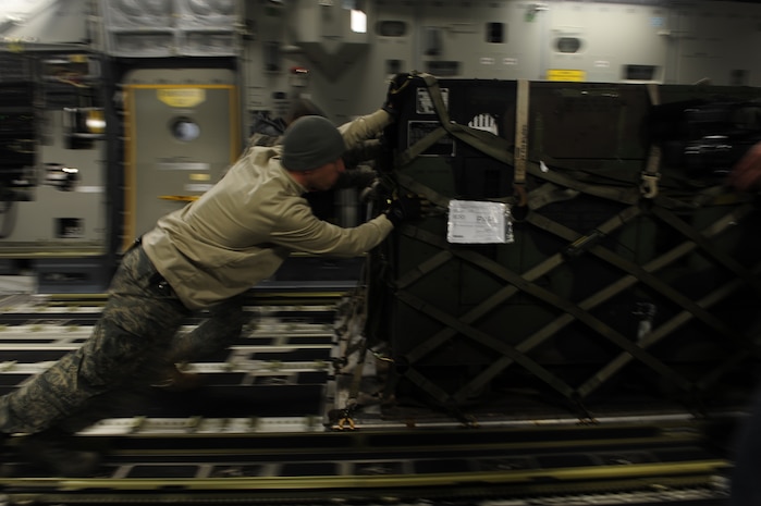 U.S. Air Force personnel from the 621st   Contingency Response Wing, Joint Base McGuire-Dix-Lakehurst, N.J., load cargo onto a Charleston Air Force Base, S.C., C-17 Globemaster III, supporting a swift and coordinated relief effort to Haiti, Jan. 14, 2010, in the aftermath of a devastating earthquake.  (U.S. Air Force photo by Staff Sgt. Joshua L. DeMotts) (Released)
