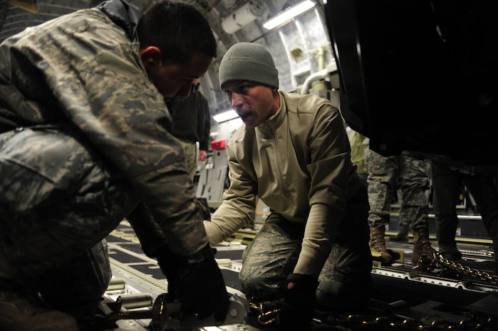 U.S. Air Force personnel from the 621st   Contingency Response Wing, Joint Base McGuire-Dix-Lakehurst, N.J., load cargo onto a Charleston Air Force Base, S.C., C-17 Globemaster III, supporting a swift and coordinated relief effort to Haiti, Jan. 14, 2010, in the aftermath of a devastating earthquake.  (U.S. Air Force photo by Staff Sgt. Joshua L. DeMotts) (Released)