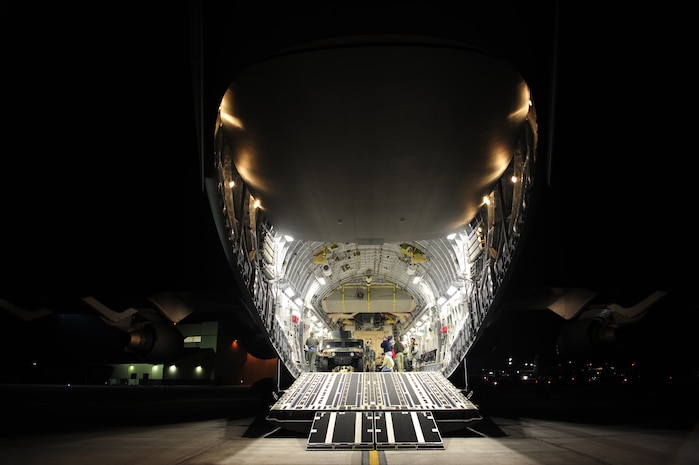 U.S. Air Force personnel from the 621st   Contingency Response Wing, Joint Base McGuire-Dix-Lakehurst, N.J., load cargo onto a Charleston Air Force Base, S.C., C-17 Globemaster III, supporting a swift and coordinated relief effort to Haiti, Jan. 14, 2010, in the aftermath of a devastating earthquake.  (U.S. Air Force photo by Staff Sgt. Joshua L. DeMotts) (Released)